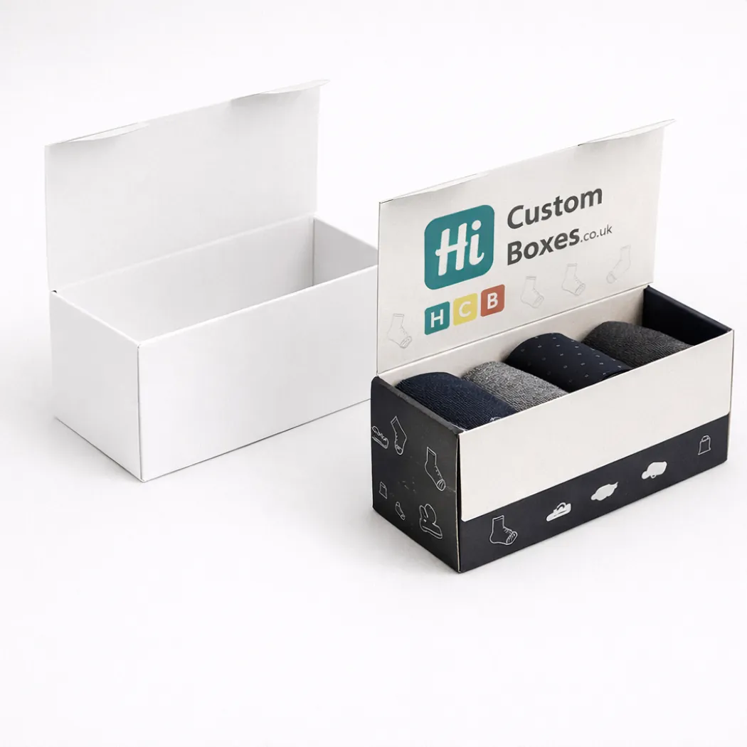 Two rectangular hinged lid boxes- one plain white and one printed with black sock patterns- class=